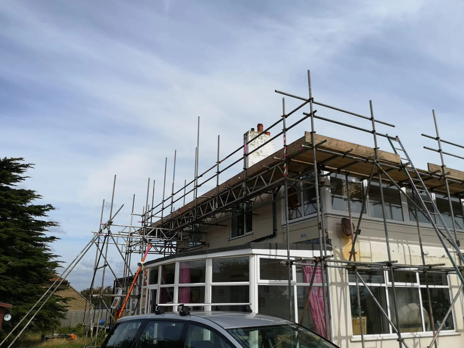 Scaffold over a conservatory giving access to the roof